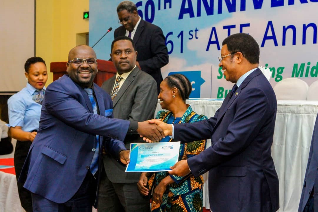 Eric Sambu receiving award