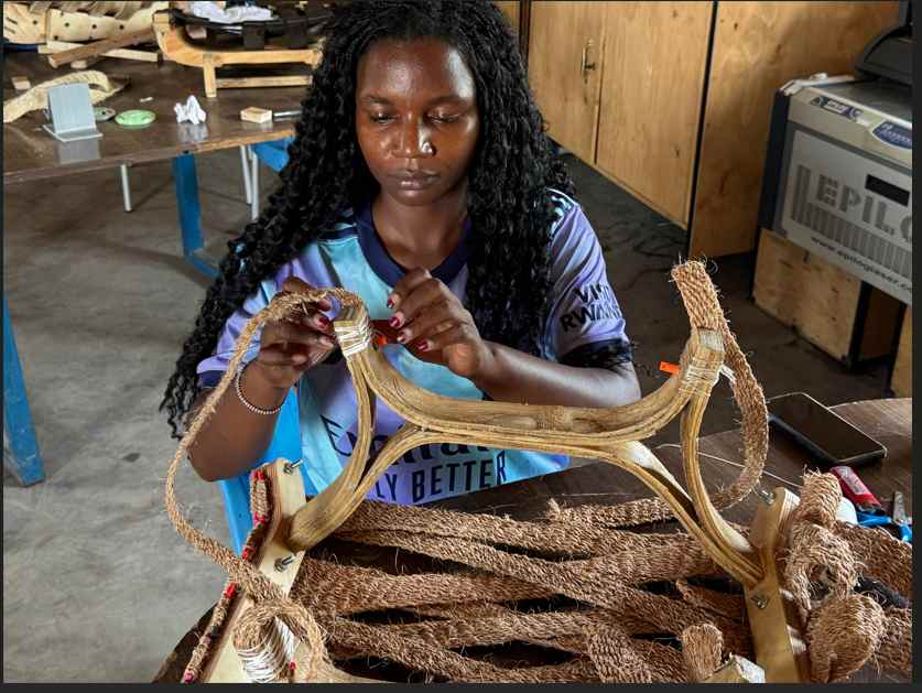 Craftsperson weaving the seat surface by hand at FabLab Winam