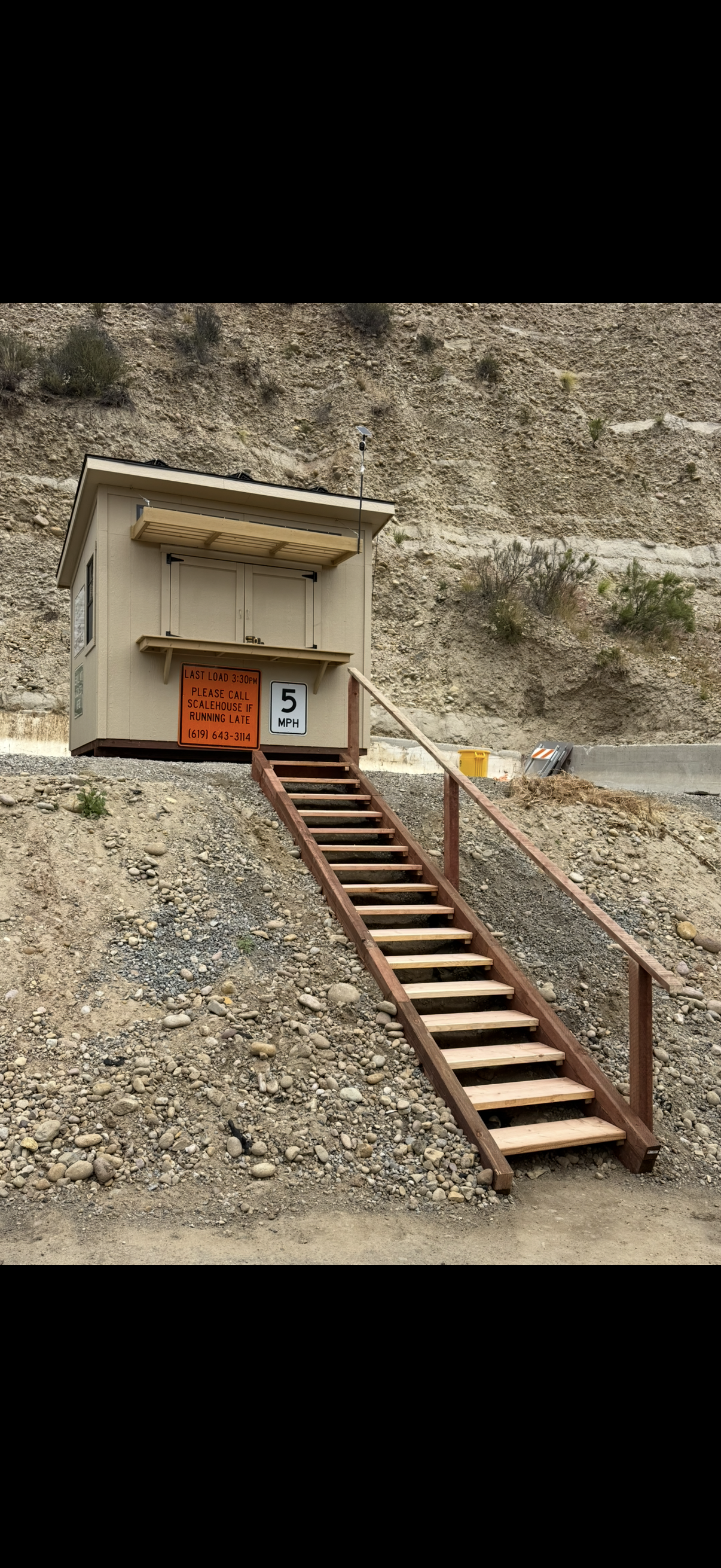 Exterior wood staircase with steel pipe handrail