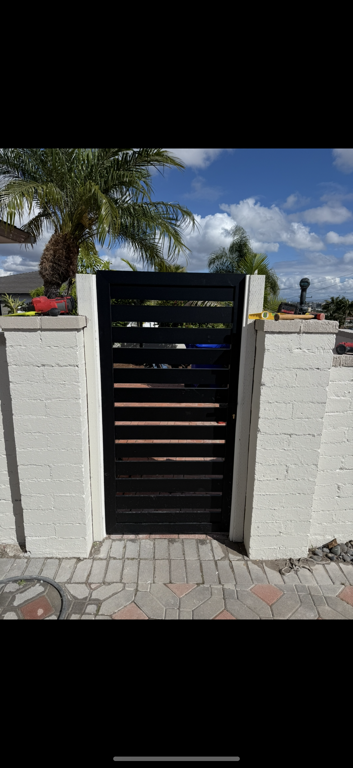 Horizontal slat privacy gate between stucco columns