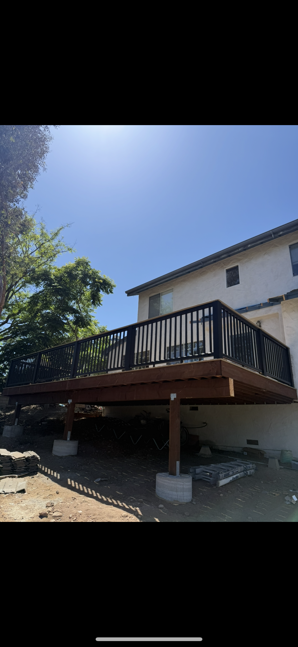 Elevated wood deck with black metal railing