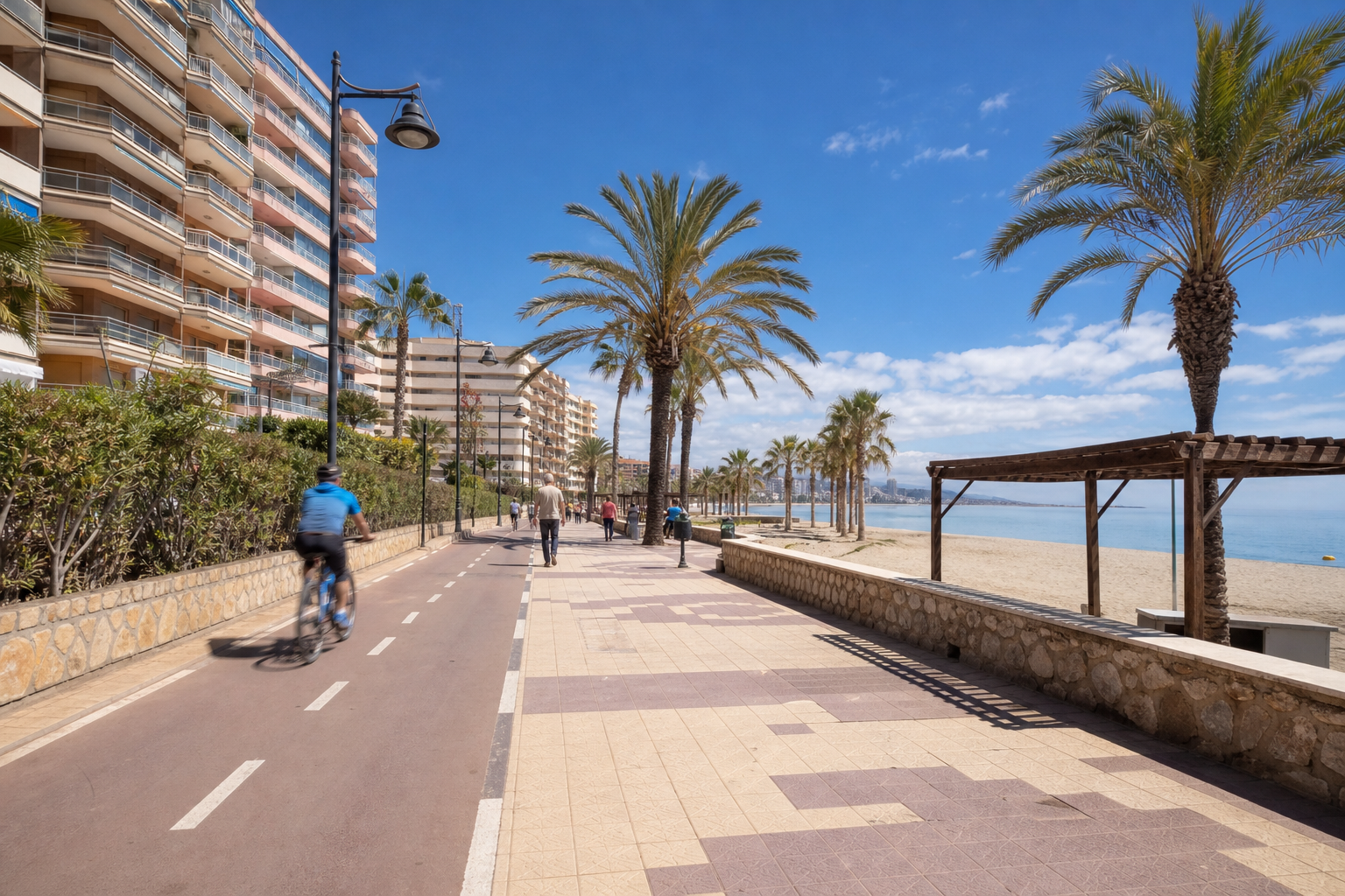A scenic view of Fuengirola's coastline with bike lanes and pedestrians.