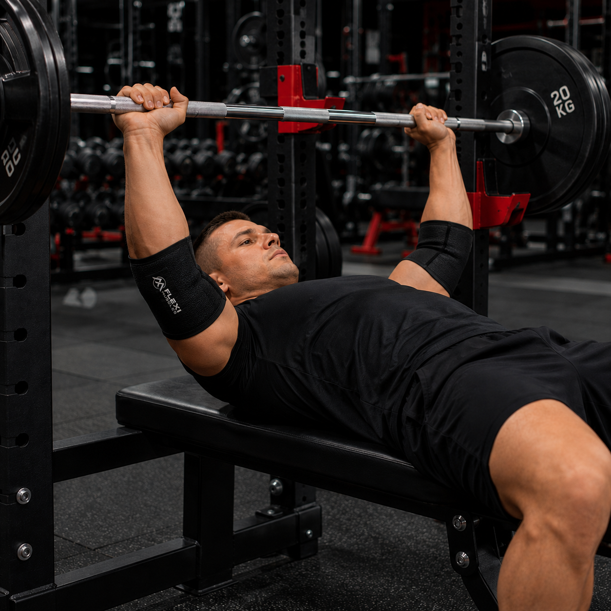 Close-up of a man wearing an elbow strap during a barbell bench press, showing the elbow support in use