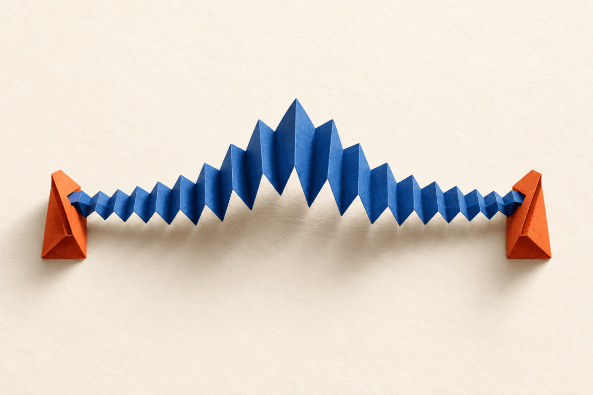 An ultramarine accordion-folded paper spring rises into a sharp central crest between two orange paper brackets on an ivory background.