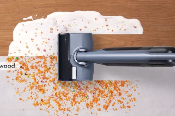 An innovative vacuum cleaner effortlessly tackles spills and debris on both wood and tile floors.