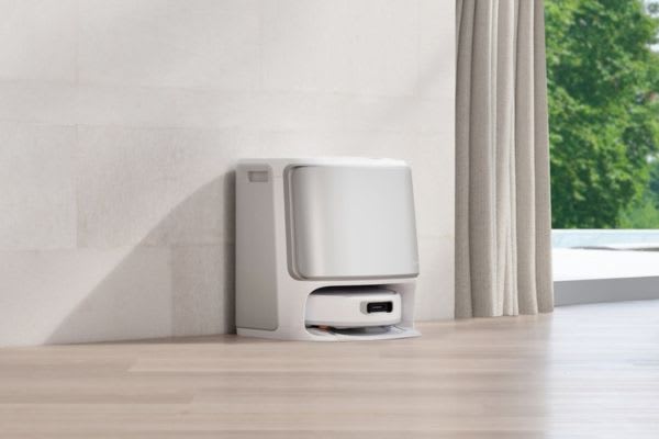A sleek robot vacuum dock positioned against a wall, showcasing features for how to use robot vacuum on multiple floors.