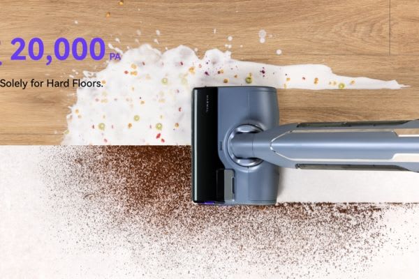 A vacuum cleaner on a hard floor, showcasing how to get hair out of vacuum roller while cleaning up different messes.