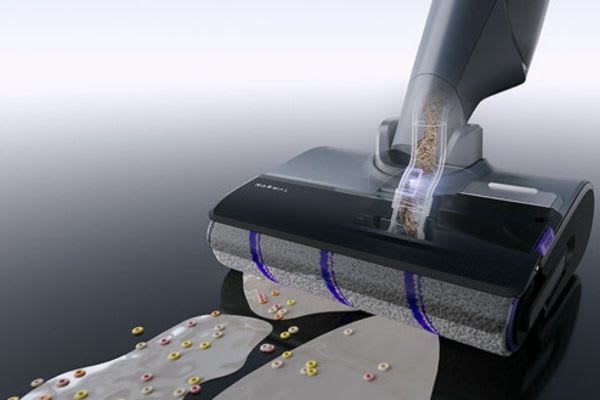 A close-up view of a vacuum cleaner picking up debris, showcasing the efficiency of dust mop vs vacuum cleaning methods.