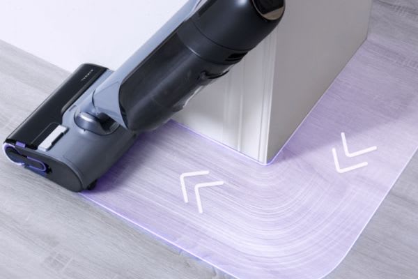 A vacuum cleaner is used to clean around edges, highlighting the practicality of dust mop vs vacuum for effective cleaning.