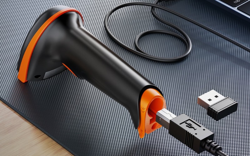 A close-up of a scanner with orange accents, highlighting its USB connection and scanner accessories for easy setup.