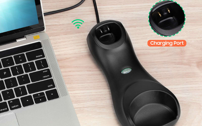 A barcode scanner hardware charger dock connected to a laptop, featuring a charging port and wireless signal icon.