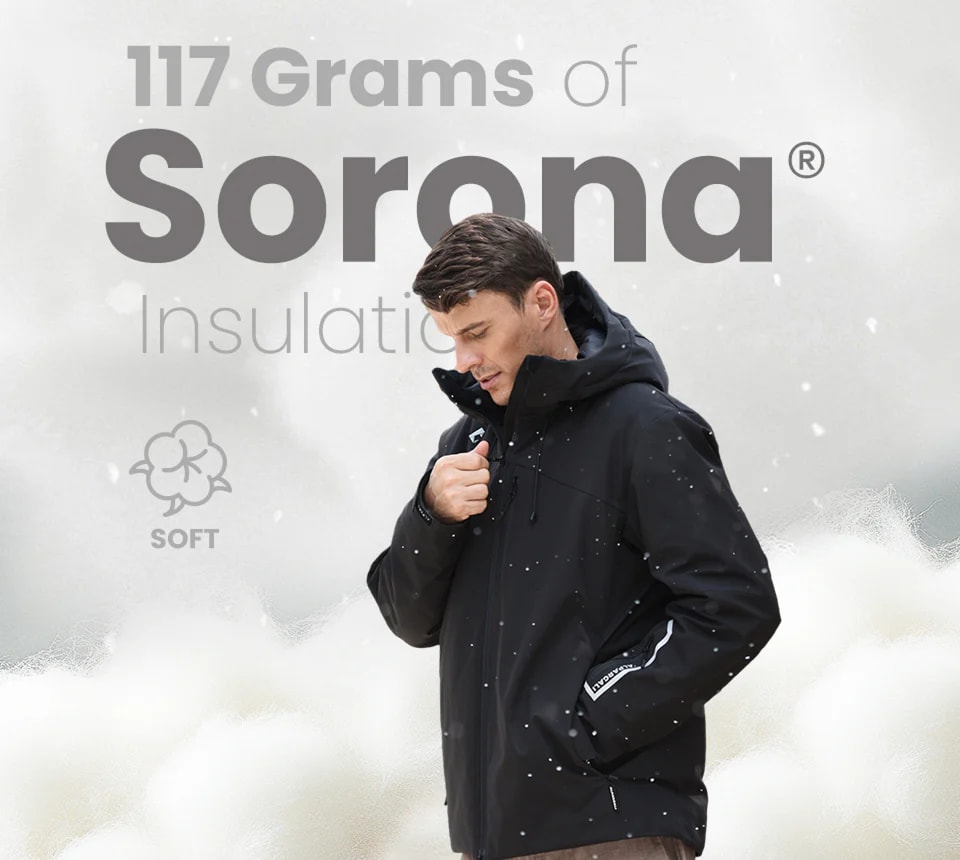 A man wearing a black jacket with 117 grams of Sorona fabric insulation, showcasing warmth and softness in a snowy setting.