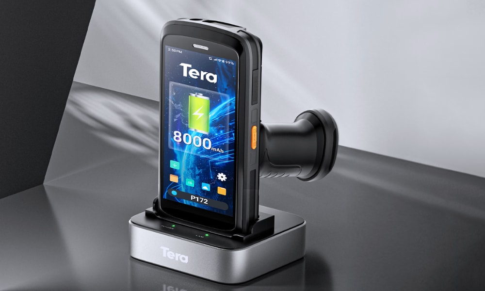 A warehouse scanner on a charging dock, featuring a large display that shows battery capacity and device status.