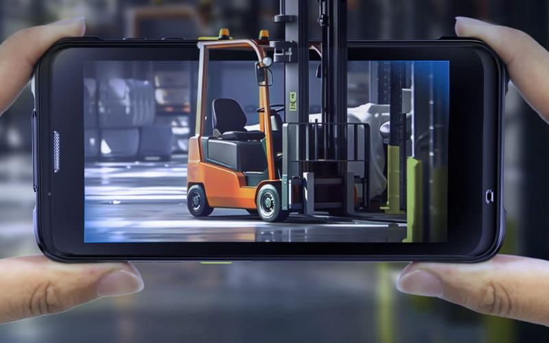 A person captures a forklift image on a mobile device, showcasing advanced industrial barcode scanners in action.
