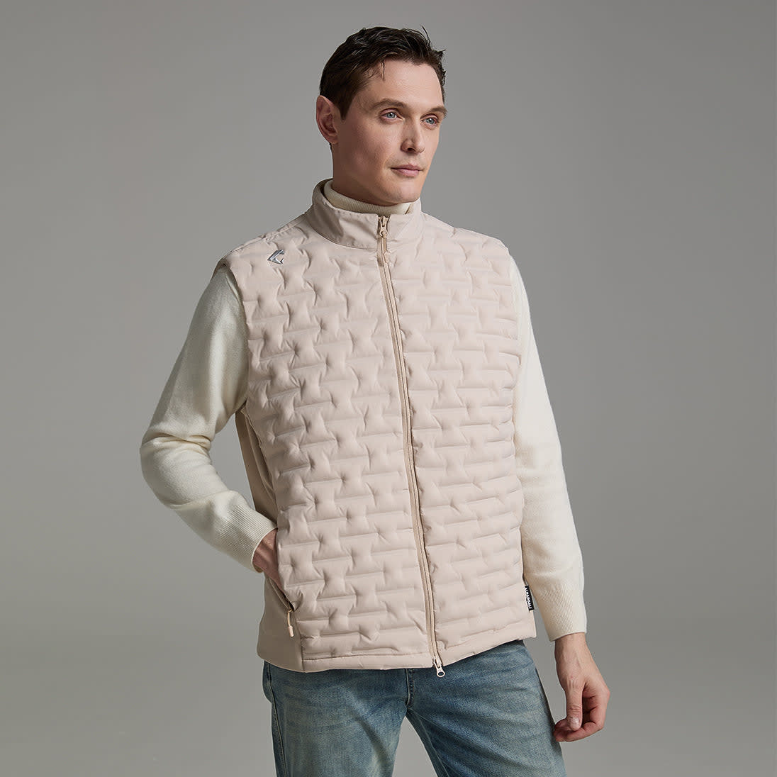 A stylish man models a light down vest, showcasing a modern look in the down vest vs jacket debate.