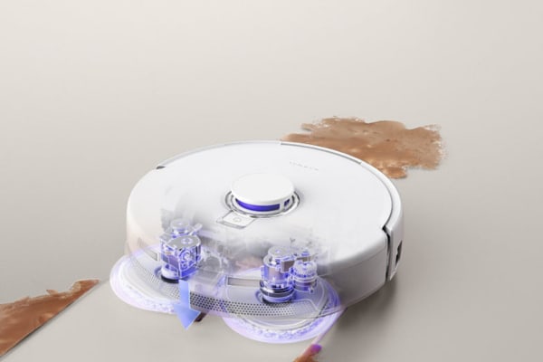A dusting robot efficiently cleans up a spilled substance, showcasing advanced cleaning technology and design.