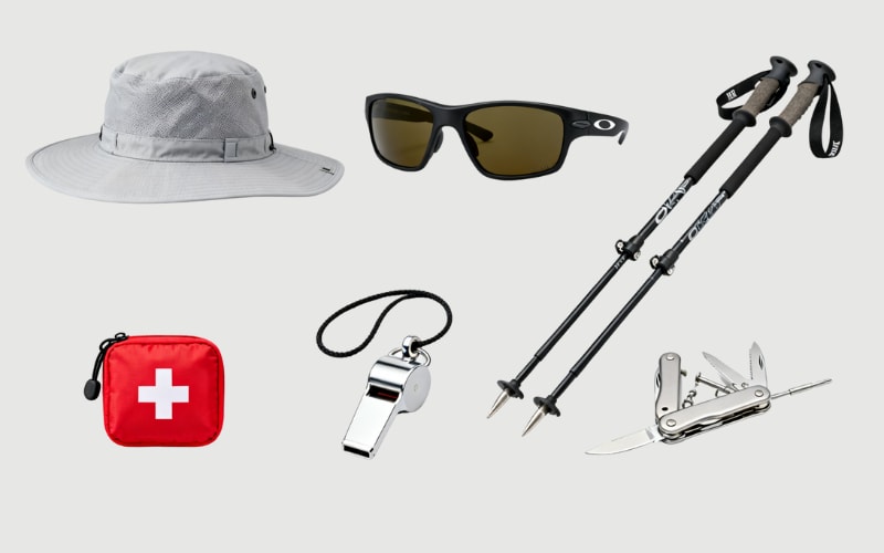 Essential gear for outdoor adventures, including hiking clothes, sun protection, and safety tools.