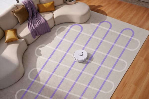 A robot vacuum cleans a living room, demonstrating mapping versus no mapping with visible cleaning paths.