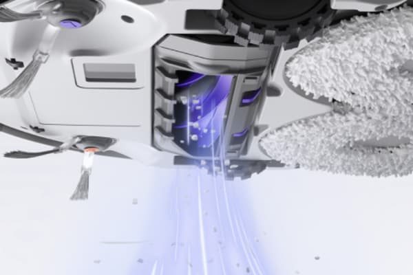 A close-up view of a vacuum cleaner's underside demonstrating how to measure vacuum suction.