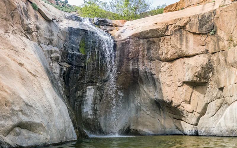 A scenic waterfall cascading over rocky cliffs, featuring natural beauty, perfect for the best hikes in San Diego.