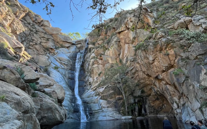 A stunning waterfall cascading down rocky cliffs, showcasing one of the best hikes in San Diego.
