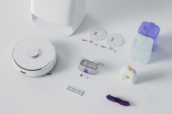 Robot vacuum with docking station and accessories including filters, brushes, and cleaning containers.