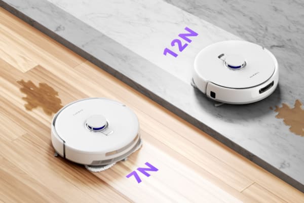 A robot vacuum with docking station features two models on different surfaces, showcasing cleaning power.