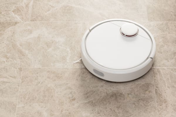 A sleek robot vacuum cleaner designed for efficient cleaning on marble floors, ensuring a spotless finish.
