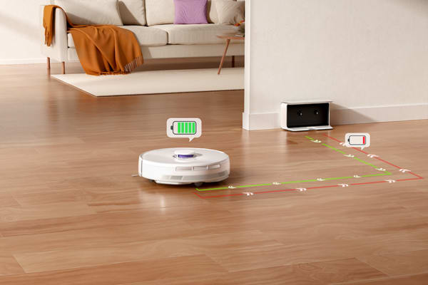 A robot vacuum with remote control navigates the floor, charging station in the background.
