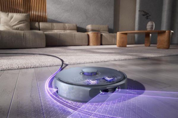 A modern robot vacuum cleaning a stylish living room, showcasing useful robot vacuum hacks in action.