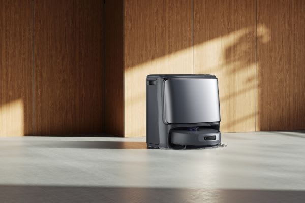 A modern robot vacuum stands in a spacious, minimally decorated room, illustrating how to turn off robot vacuum.