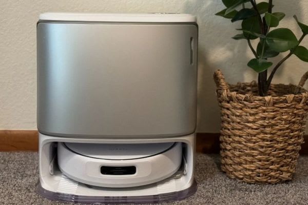 A robot vacuum discreetly stored in a sleek container, showcasing a smart solution for how to hide robot vacuum.