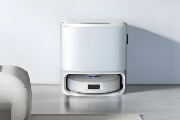 A sleek white storage unit conceals a robot vacuum, demonstrating how to hide robot vacuum devices effectively.