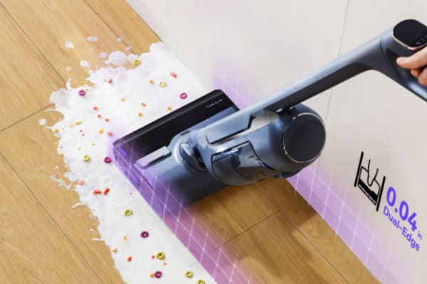 A robot vacuum cleans a liquid spill on the floor, raising the question: Can You Vacuum Liquid Spills with a Robot Vacuum?