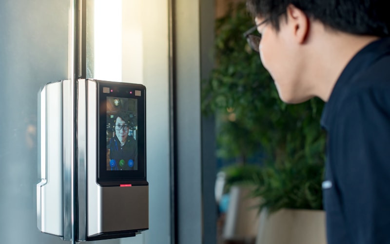 A person interacting with a biometric device, showcasing automatic identification and data capture technology.