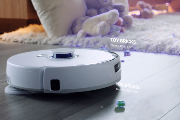 A sleek robot vacuum navigates around scattered toy bricks, demonstrating the best robot vacuum to avoid pet waste efficiently.