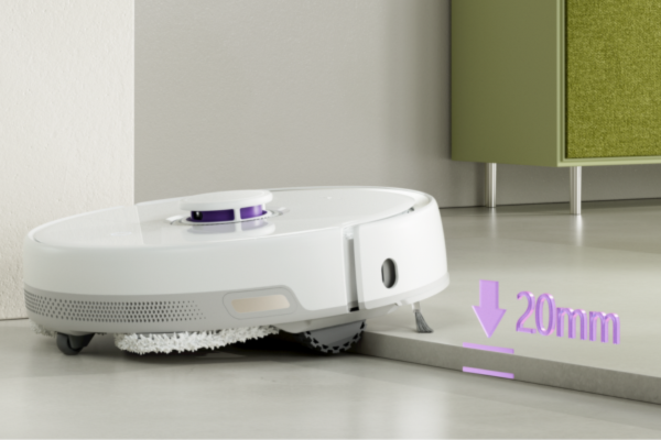 A robot vacuum is navigating near a threshold, highlighting the importance of understanding how to troubleshoot your robot vacuum’s navigation issues.