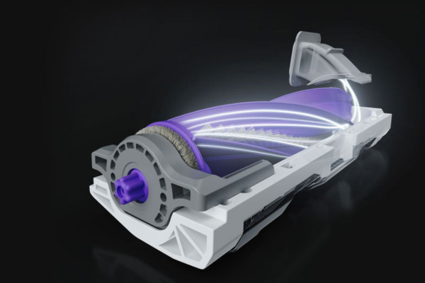 A detailed view of a vacuum's beater bar, showing its brush mechanism designed for effective carpet cleaning.