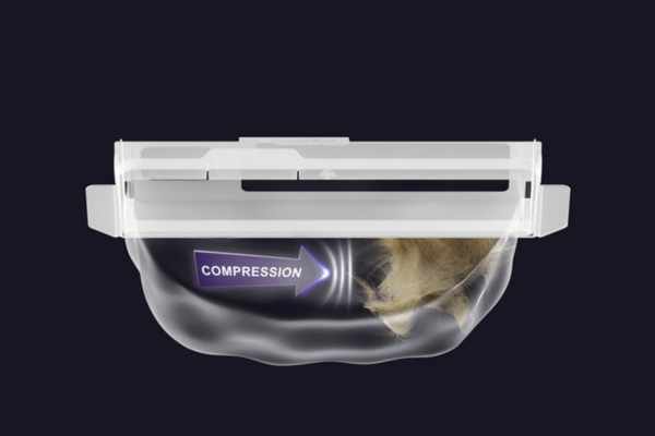 A vacuum component showing compression of hair, illustrating why is my vacuum spitting stuff back out.