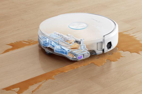 A robotic vacuum cleaner in action demonstrates what is spot cleaning by tackling a spilled liquid on the floor.