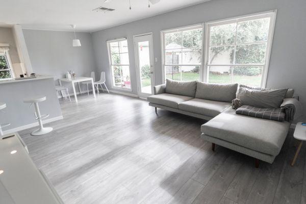 A bright and modern living space with a cozy sofa, perfect for vacation home cleaning and relaxation.