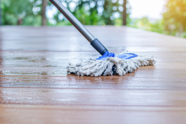 A mop glides across a shiny wooden floor, demonstrating how to mop effectively for a clean finish.