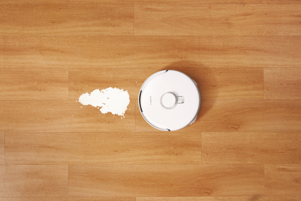 A robotic mop cleaning a spill on wooden flooring, demonstrating how to mop effectively with modern technology.