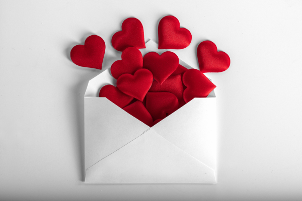 An open envelope overflowing with red hearts, perfect for Valentine's Day gifts to express love and affection.