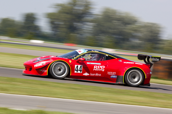 A red racing car speeds around the track, perfect for adrenaline lovers looking for unique Valentine's Day gifts.