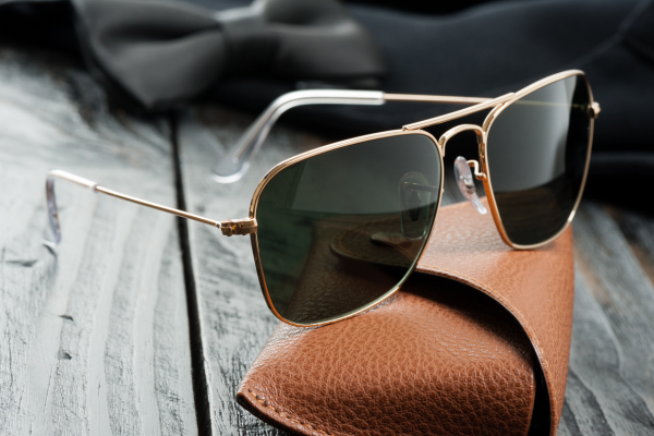 Stylish sunglasses resting on a brown leather case, perfect for unique Valentine's Day gifts.