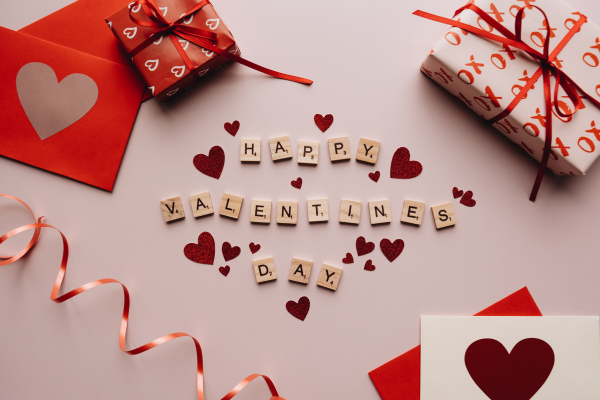 Colorful Valentine's Day decorations with gifts, hearts, and letter tiles spelling