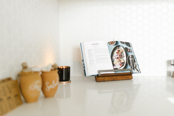 A stylish kitchen scene featuring a recipe book on a stand, perfect for Mother's Day gifts and cooking inspiration.