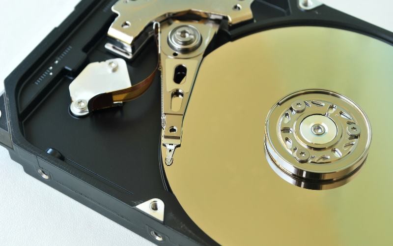 An internal view of a hard drive showcasing the components of common storage devices for data retrieval and storage.