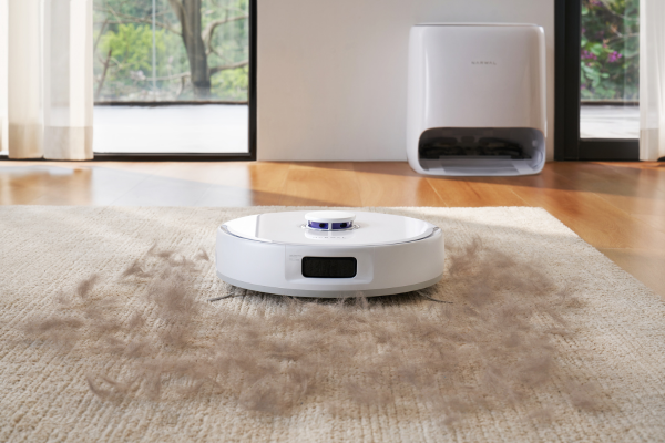 A robot vacuum effectively cleaning pet hair off a carpet, showcasing the capabilities of the best robot vacuum for pet hair.